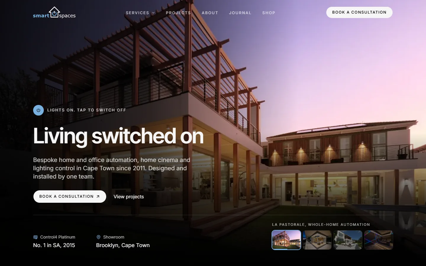 The Smart Spaces concept home page, with a lit modern house at dusk behind the line Living switched on.